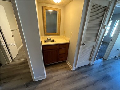 Bathroom with vanity, a textured ceiling, and wood