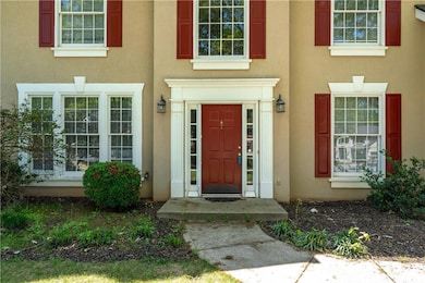 Doorway to property featuring stucco siding