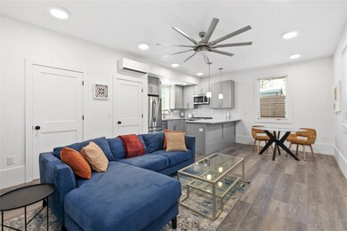 Living area featuring a wall mounted AC, ceiling 
