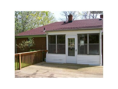 A cozy sunroom leads to deck.