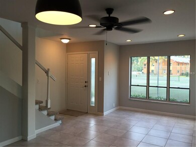 Living room has large windows, recessed lighting, 