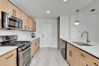 Kitchen featuring a sink, tasteful backsplash, li