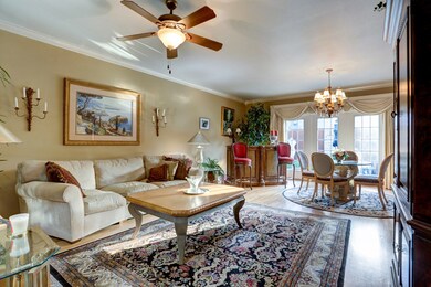 The living room features crown molding, ceiling fa