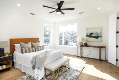Bedroom featuring wood finished floors, baseboard