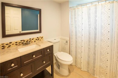 Bathroom featuring vanity, tile patterned flooring, and a shower with curtain