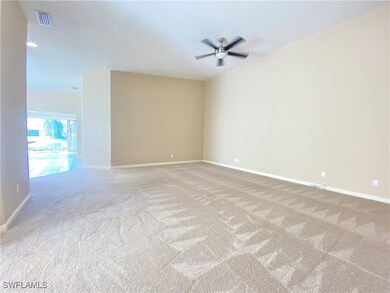 Unfurnished room featuring lofted ceiling, light c