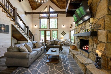 Living room with wood ceiling, a stone fireplace, 