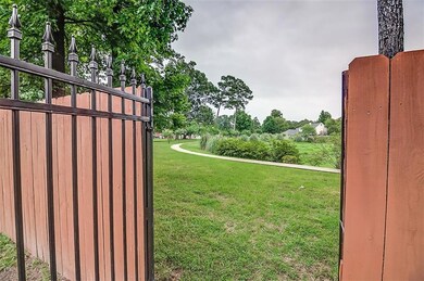 Wrough Iron gate opens to the walking trails