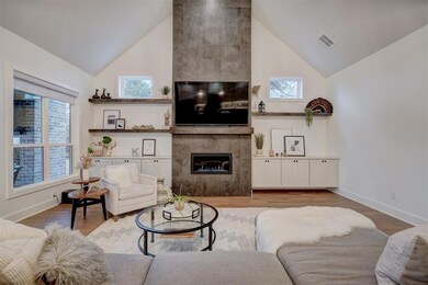 Living room featuring a tile fireplace, a wealth o