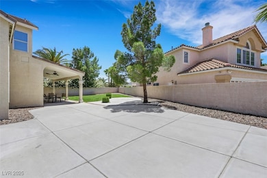 Fenced backyard with ceiling fan and a patio area