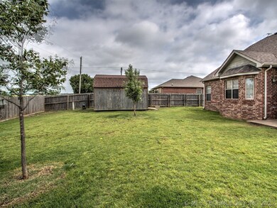 Fully fenced yard with shed.