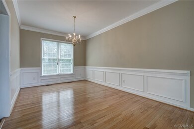 Dining Room with Hardwood Floors, Wainscoting, Cha
