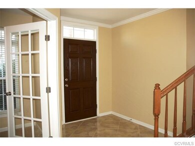 Foyer with tile floor, crown moulding, transom ove