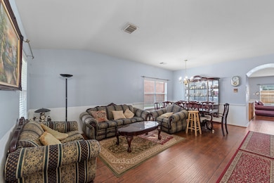 Dining area features elegant wood flooring.  Large