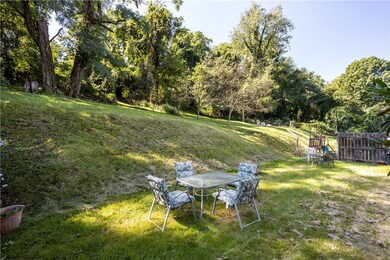 Large backyard that goes up into the hillside, all