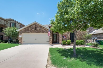 View of front of property with a garage and front yard