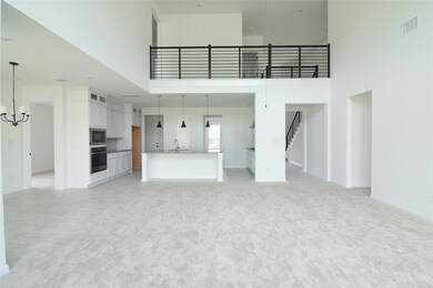 Unfurnished living room featuring a towering ceil
