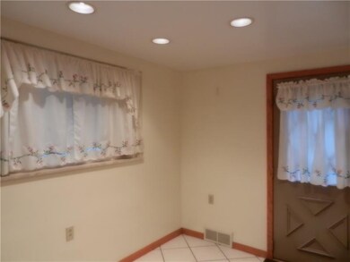 Spacious eating area of kitchen.  Ceramic tile flo