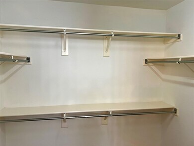 View of walk in closet in primary bedroom