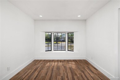 Spare room with dark hardwood / wood-style floors