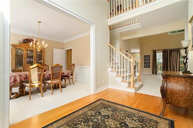 Entryway featuring wood finished floors, stairs, o