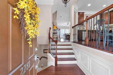 Stairway with wood finished floors, a ceiling fan, ornamental molding, and recessed lighting