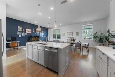 Kitchen with white cabinets, a kitchen island with