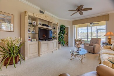 Carpeted living room featuring crown molding and c