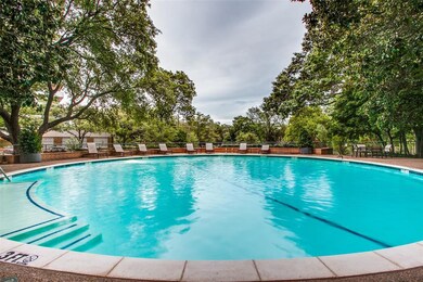 Lush magnolias surround the outdoor pool and provi