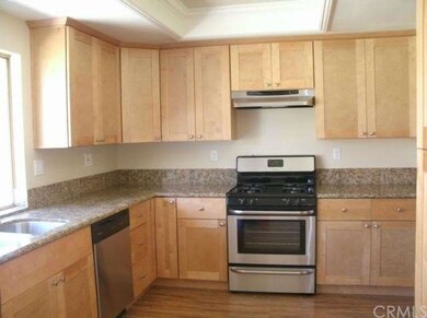 Brand new kitchen with honey shaker cabinets, slab