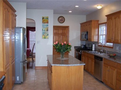 Kitchen with center island and tiled backsplash