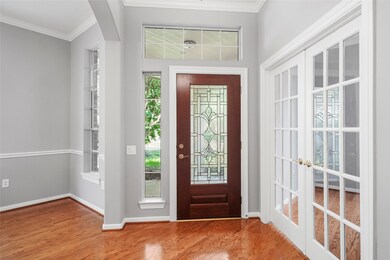 View of the front door and entry into the home office.
