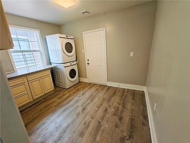 Utility room with rear exterior door.