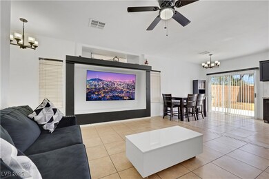 Living area featuring ceiling fan with notable cha