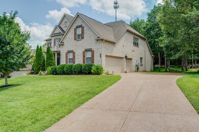 Three car side entry attached garage with extra driveway parking. Private backyard with mature trees.