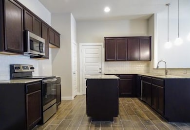 Kitchen featuring appliances with stainless steel