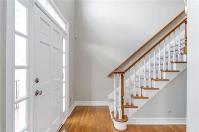Entryway with wood finished floors and stairs