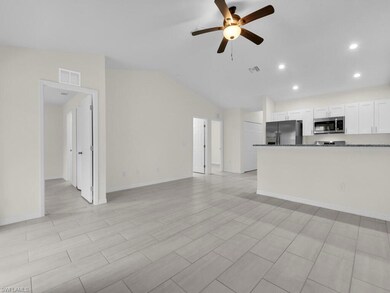 Unfurnished living room with ceiling fan, recessed lighting, vaulted ceiling, and baseboards