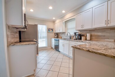 Kitchen featuring light tile patterned floors, sin