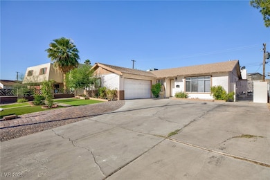 Ranch-style home with concrete driveway, an attach