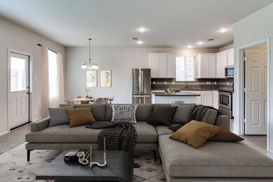 Tiled living room with a notable chandelier