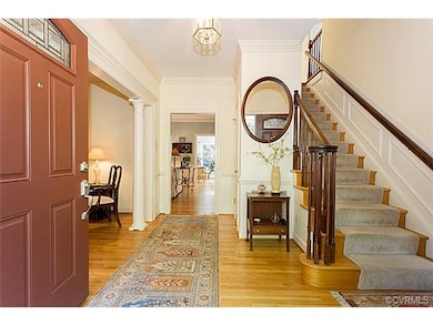 Large entry foyer with crown molding, chair railin