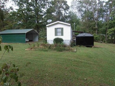 View of shed with a detached carport