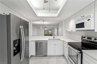 Kitchen featuring stainless steel appliances, a sink, ceiling fan, white cabinetry, and recessed lighting