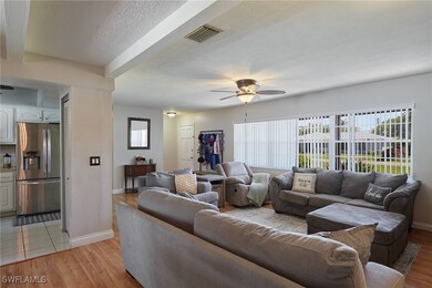 Living room featuring visible vents, plenty of nat