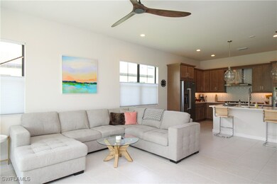 Tiled living room featuring ceiling fan