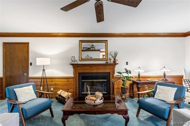 Living room featuring ceiling fan and carpet