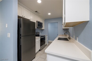 Kitchen includes stainless steel appliances white
