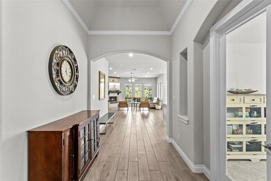 Corridor with light wood-style floors, arched wal