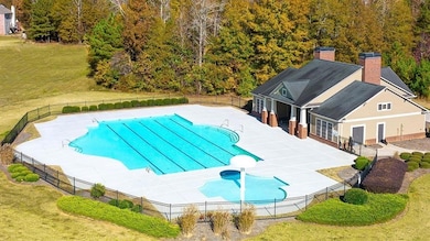Community pool featuring a patio area, a yard, and